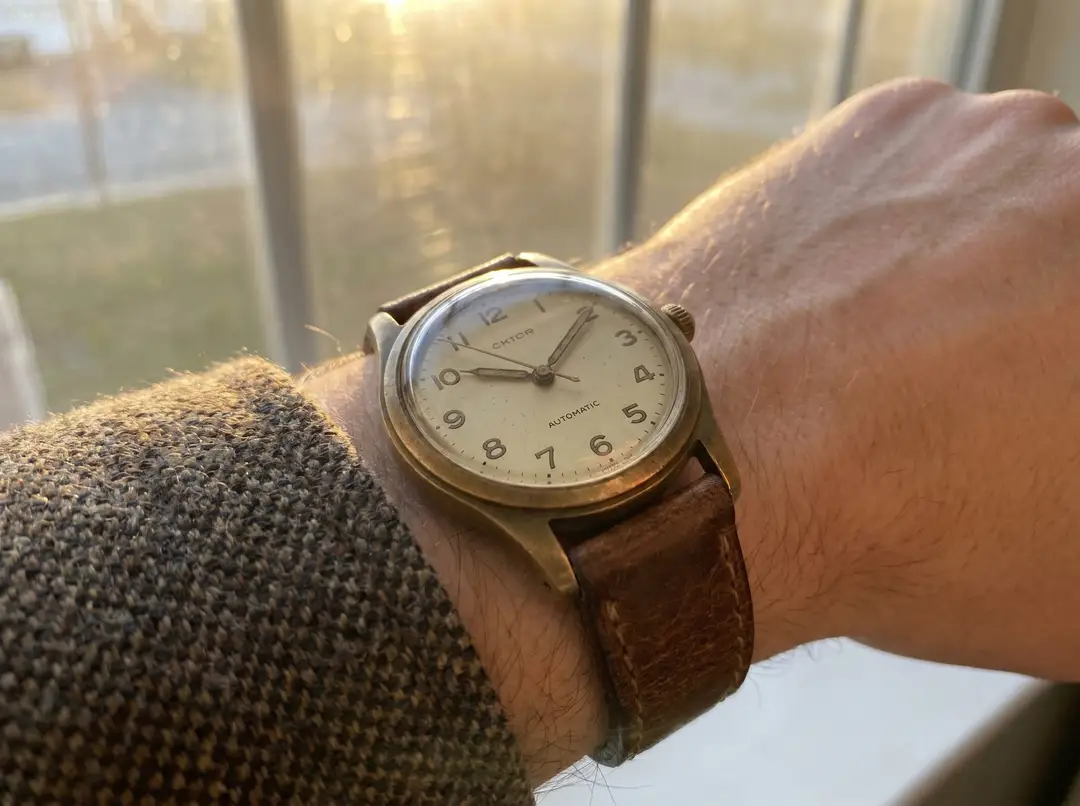 Vintage analog wristwatch in warm window light